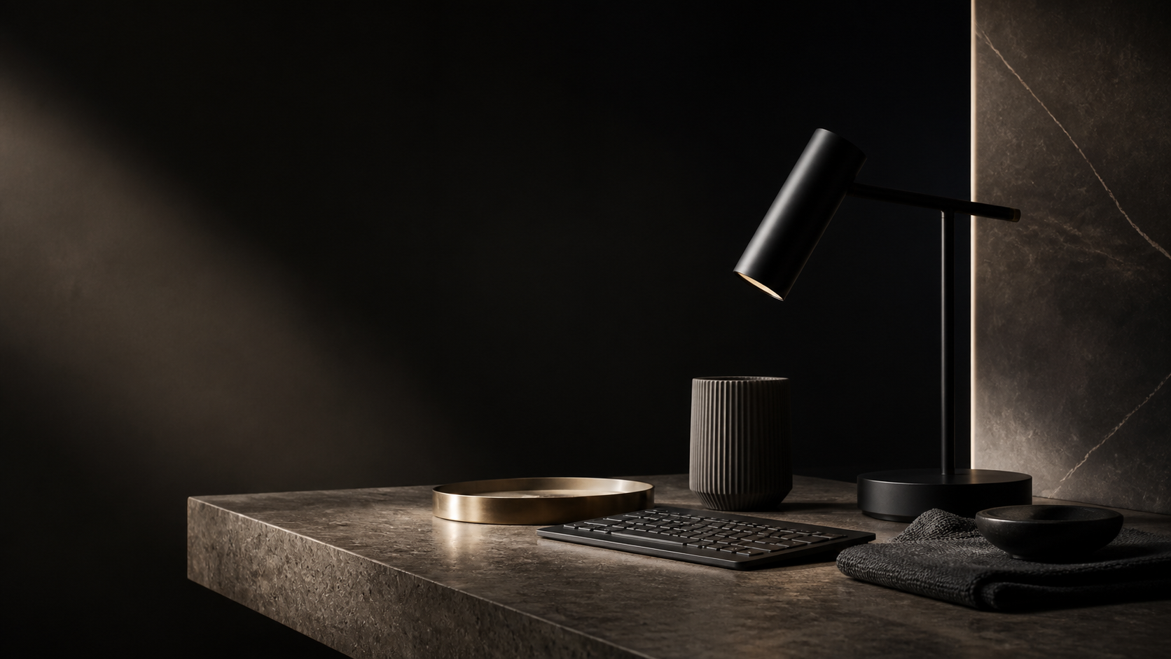 Luxury still life of sculptural workspace objects on dark stone